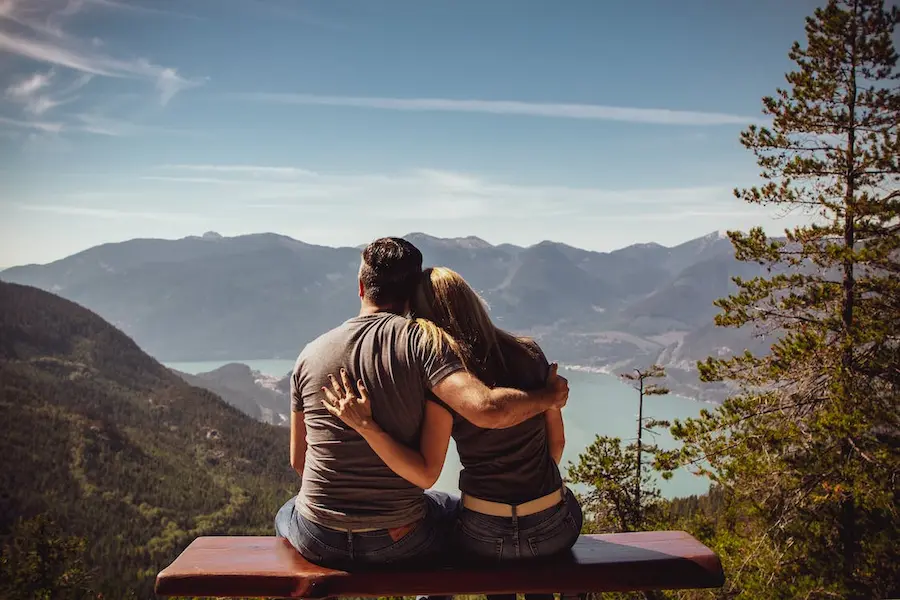 Two people sitting on a bench in the nature